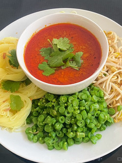 A picture of Rice vermicelli with Tuna Curry Sauce.
