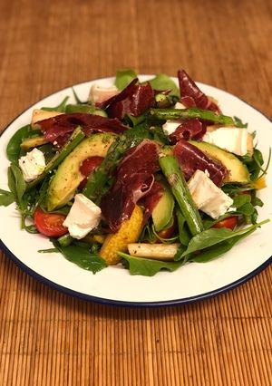 A picture of Jamon iberico, asparagus, pear and goats cheese salad.