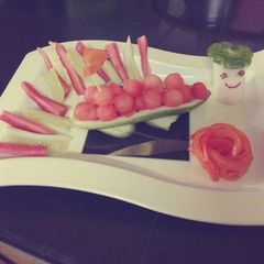 A picture of A boat of watermelon balls.