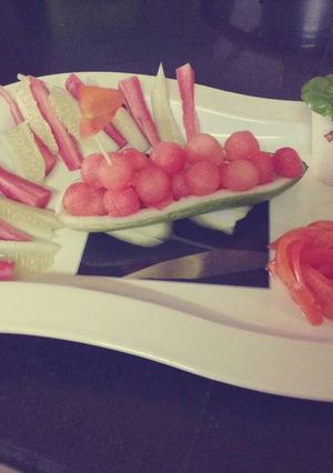 A picture of A boat of watermelon balls.