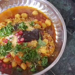 A picture of Aloo tikki and kabuli chana chat.