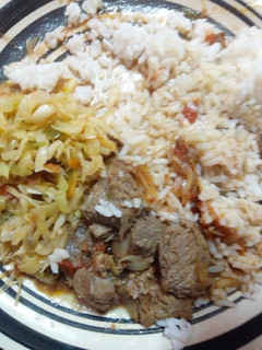 A picture of Beef stew rice and fried cabbage.