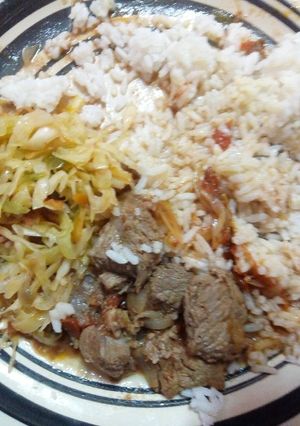 A picture of Beef stew rice and fried cabbage.