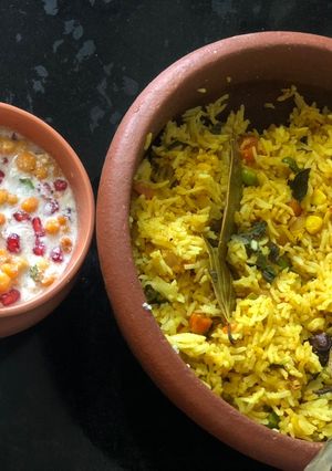A picture of Mix Vegetable pulav and pomegranate Raita.