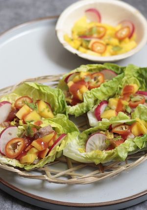 A picture of Honey, soy and lemon grass Pork with Mango in Lettuce cup.