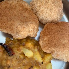 A picture of Poori (Indian deep fried bread).