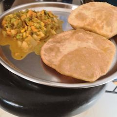 A picture of Corn Subzi with Pooris.