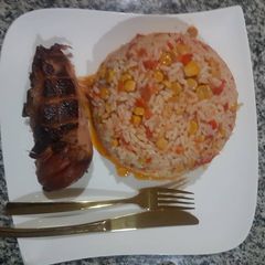 A picture of Special jollof and roasted chicken.