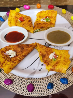 A picture of Paneer stuffed moong dal chilla.