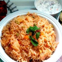 A picture of Vegetable biryani in a pressure cooker.