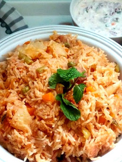 A picture of Vegetable biryani in a pressure cooker.