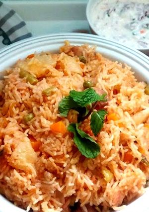 A picture of Vegetable biryani in a pressure cooker.