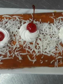 Una foto de Pionono de coco y dulce de leche