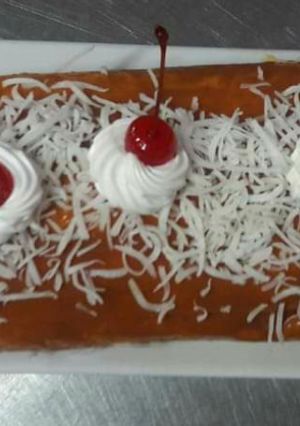 Una foto de Pionono de coco y dulce de leche