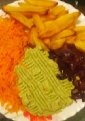 A picture of Potato wedges + guacamole+ carrots+ fried onions.