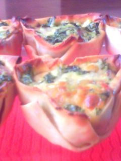 Una foto de Canastitas de espinaca, queso y panceta