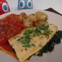 A picture of Smoked River cobbler fillets with a cherry tomato sauce.