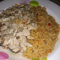 A picture of Indomie noodles with scramble eggs.
