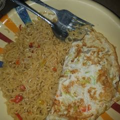 Indomie noodles and veggie fried eggs A picture of Indomie noodles and veggie fried eggs.