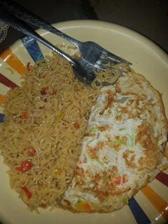 A picture of Indomie noodles and veggie fried eggs.