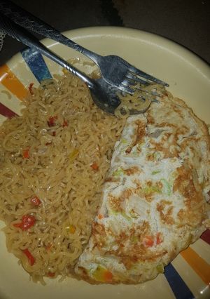 A picture of Indomie noodles and veggie fried eggs.