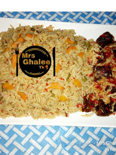 A picture of Jallof Rice with meat cabbage sauce.