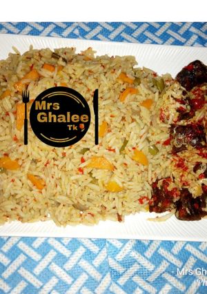 A picture of Jallof Rice with meat cabbage sauce.
