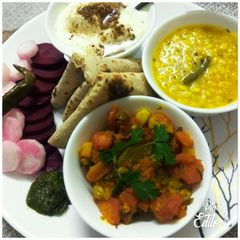 A picture of Gajar Matter veg,Dhuli Urad dal with plain curd, chapati, saled.