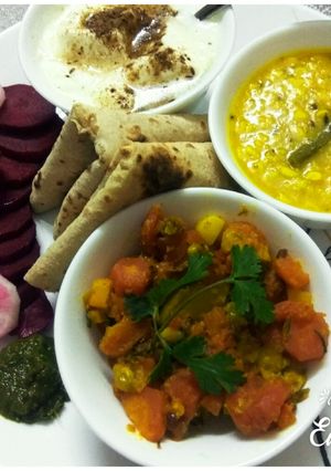A picture of Gajar Matter veg,Dhuli Urad dal with plain curd, chapati, saled.