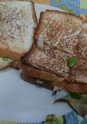 A picture of Onion omelette with bread slice.