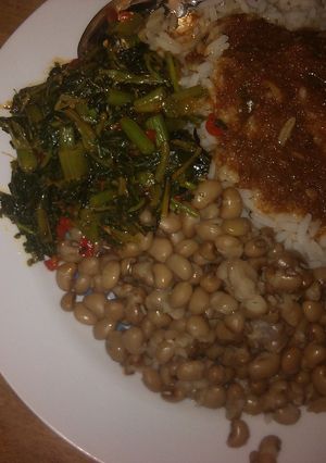 A picture of White rice,beans and spinach salad.