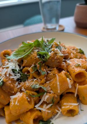A picture of Pasta alla vodka, with pork and sprouts.