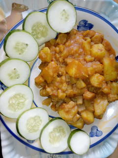 A picture of Unripe poridge plantain, sweet potatoes garnished with cucumber.