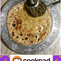 A picture of Aaloo ka paratha(potato flat bread) with mint chutney.