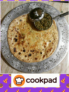 A picture of Aaloo ka paratha(potato flat bread) with mint chutney.