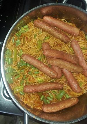 A picture of Spaghetti jollof and beef sausage.