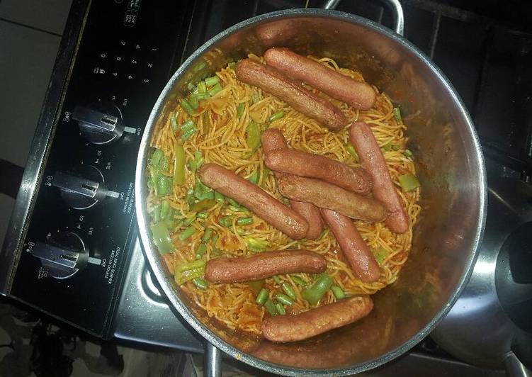 Spaghetti jollof and beef sausage