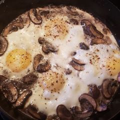 A picture of Baked Eggs with Mushrooms and Cheese.