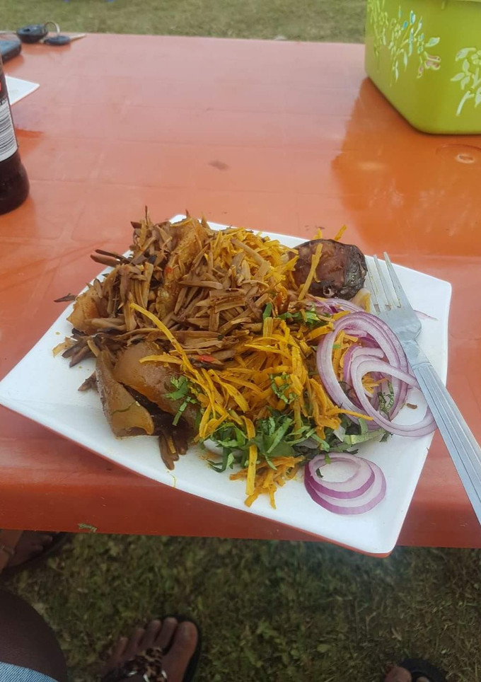 A picture of Abacha with ugba and pomo and fish.