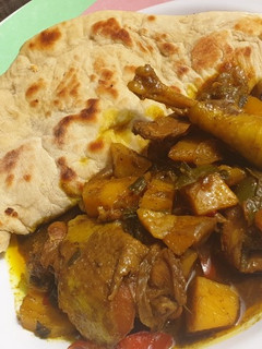 A picture of Jamaican chicken curry and chapati.