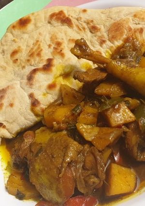 A picture of Jamaican chicken curry and chapati.