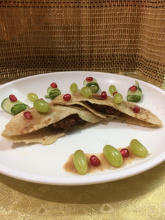 A picture of Stuffed pita bread with stuffed cauliflower kababs served with pomegranate grape sauce.