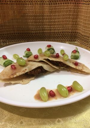 A picture of Stuffed pita bread with stuffed cauliflower kababs served with pomegranate grape sauce.