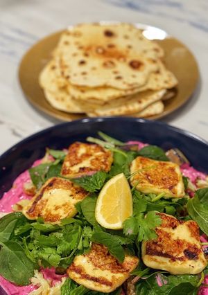 A picture of Eggplant with haloumi, beetroot, tzatziki and yogurt flatbreads.