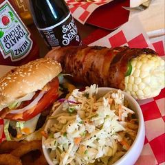 A picture of Bacon wrapped corn on the cobb.