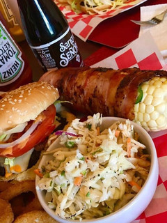 A picture of Bacon wrapped corn on the cobb.