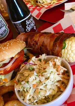 A picture of Bacon wrapped corn on the cobb.