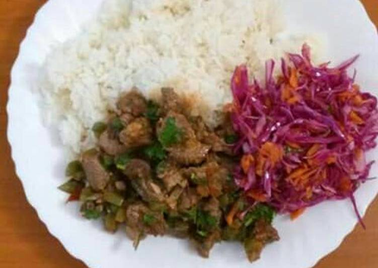 Beef stew served with rice and red cabbage