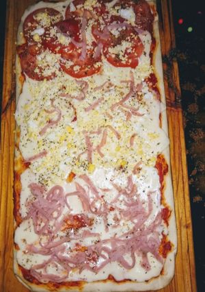 Una foto de Pizza al corte