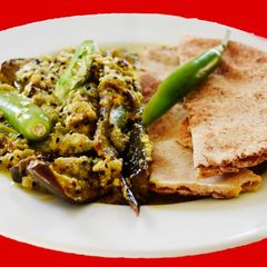 A picture of Niramish Doi Begun (Brinjal masala curry).